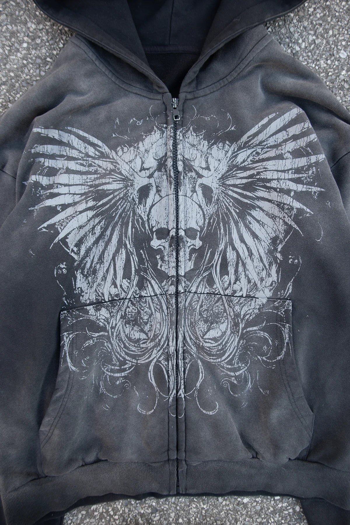 Close view of the winged graphic and faded cotton on the Rebirth zip up
