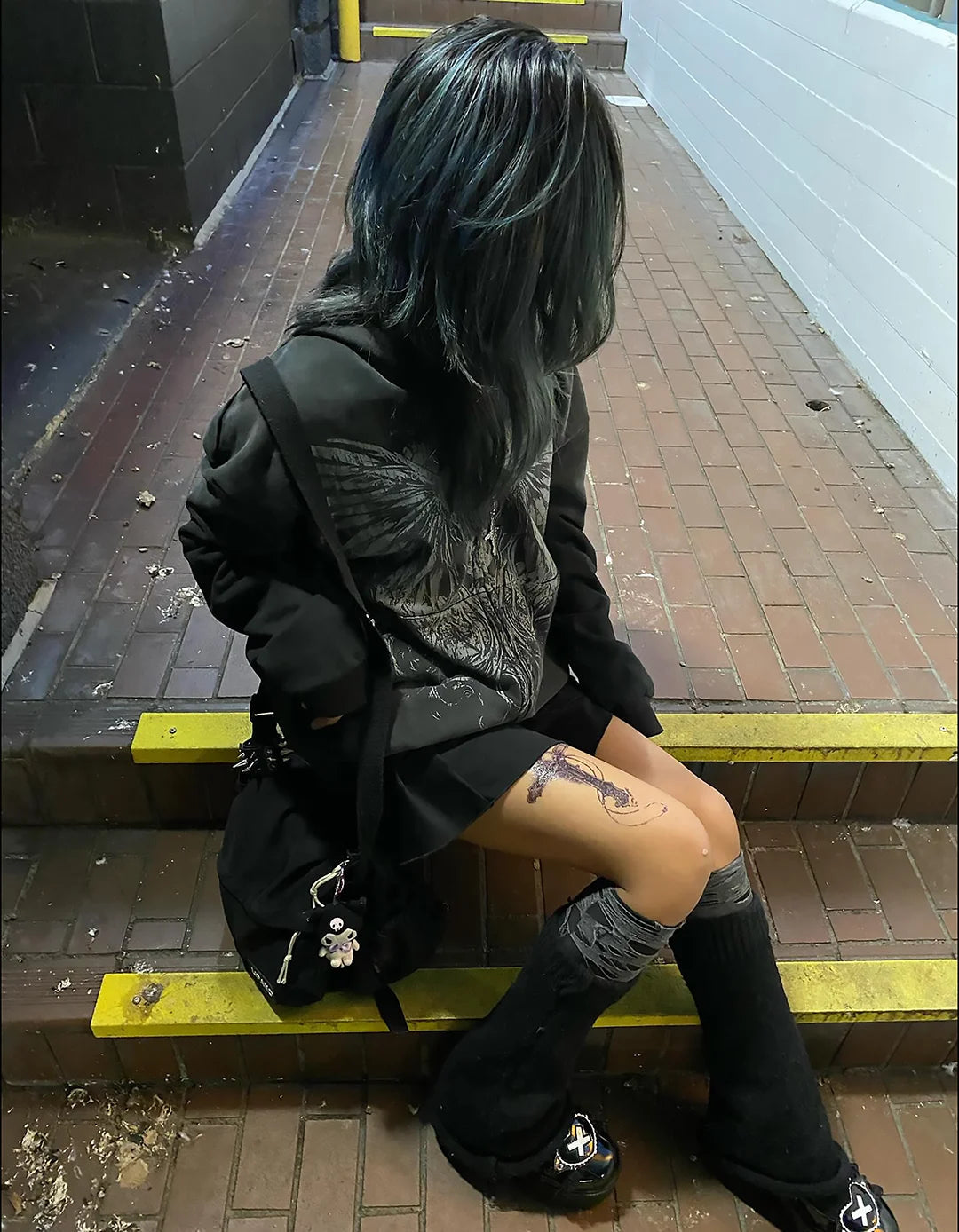 Rebirth zip up styled on an escalator at night